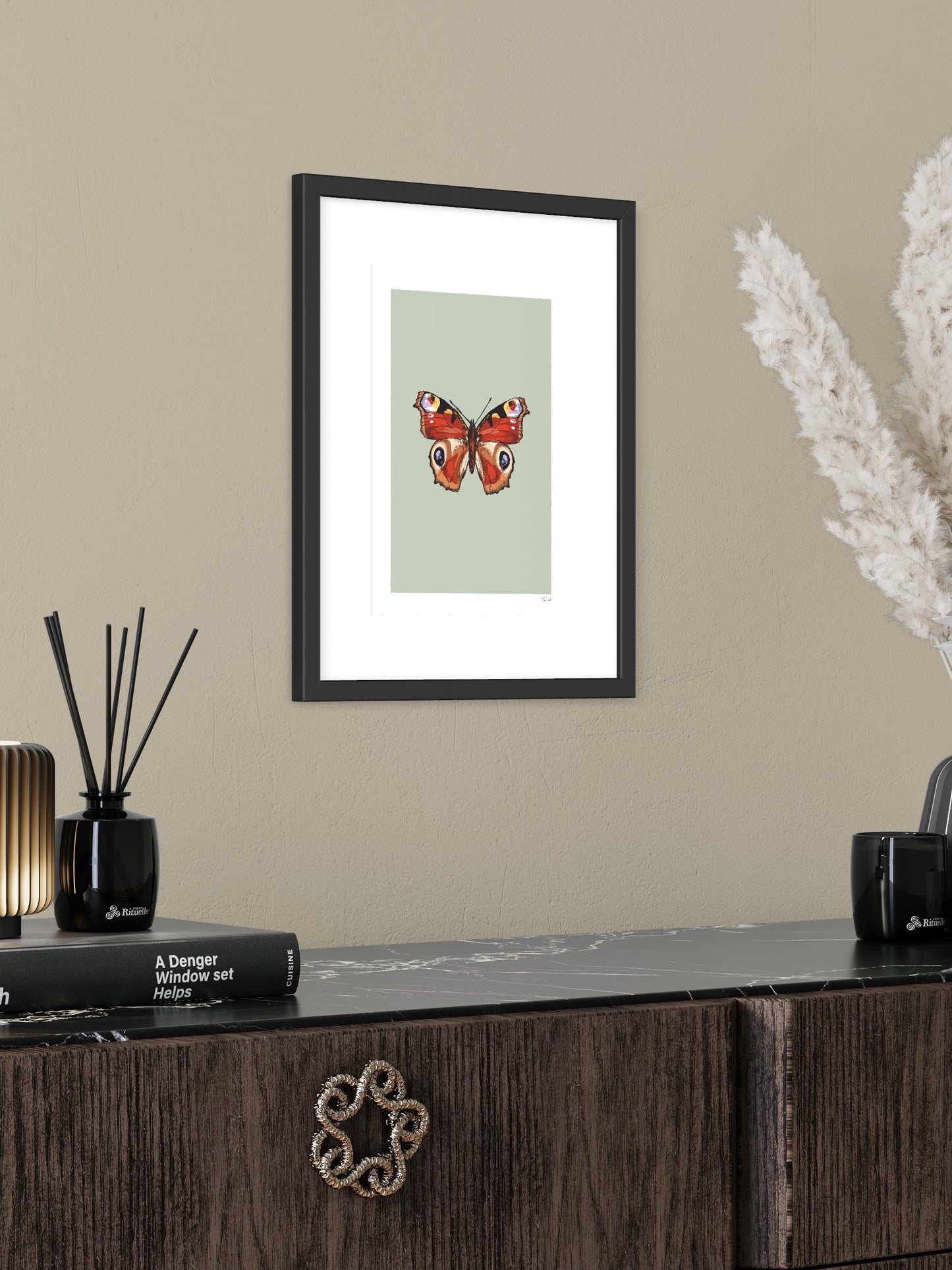 This image shows a giclee wall art print by Tom Laird Illustration of a Peacock Butterfly, framed in a beautiful living room with tasteful modern home decor. This art print is available from Tom Laird Illustration in various sizes.
