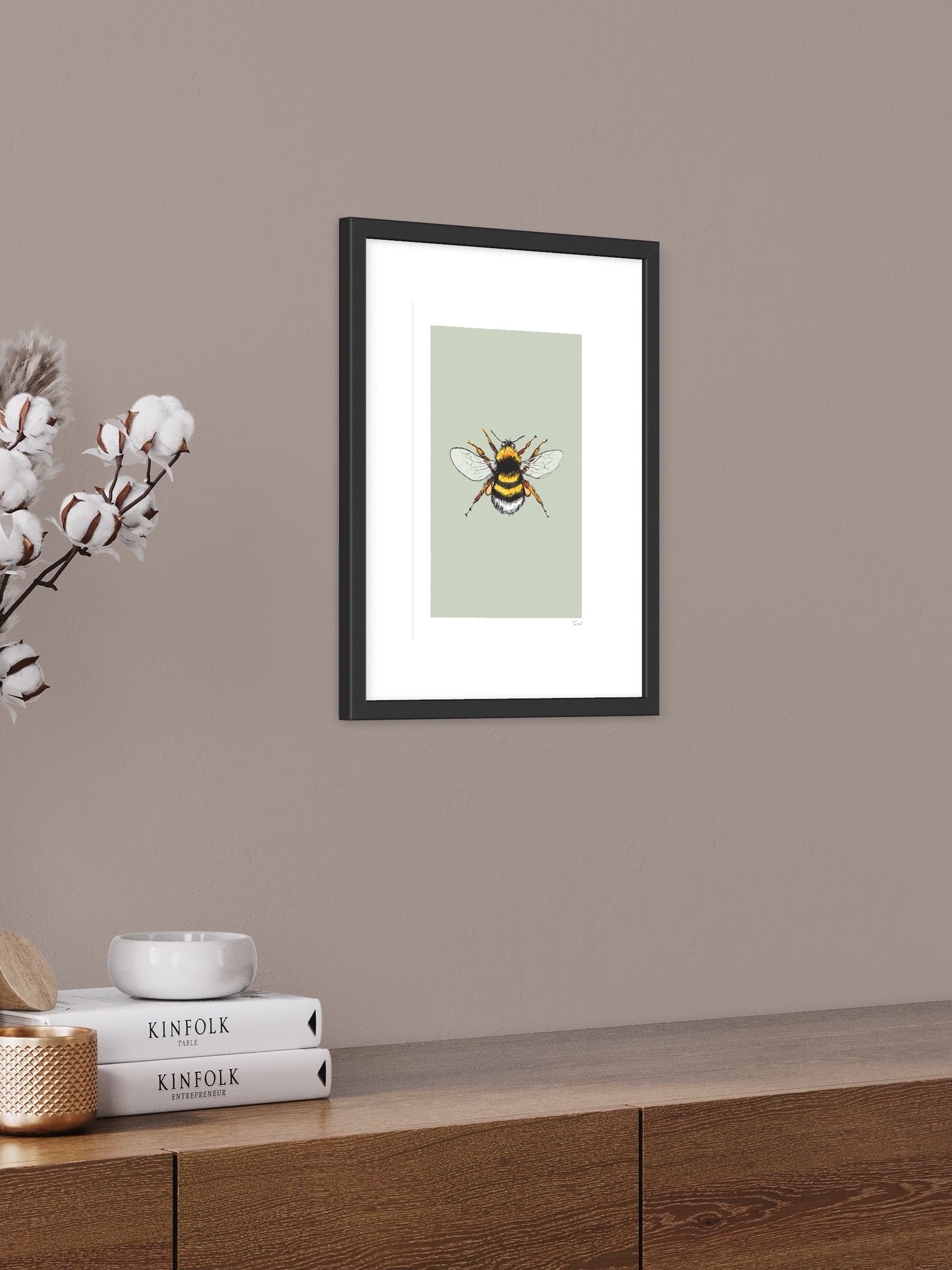 This image shows a giclee wall art print by Tom Laird Illustration of a Bumblebee, framed in a beautiful living room with tasteful modern home decor. This art print is available from Tom Laird Illustration in various sizes.