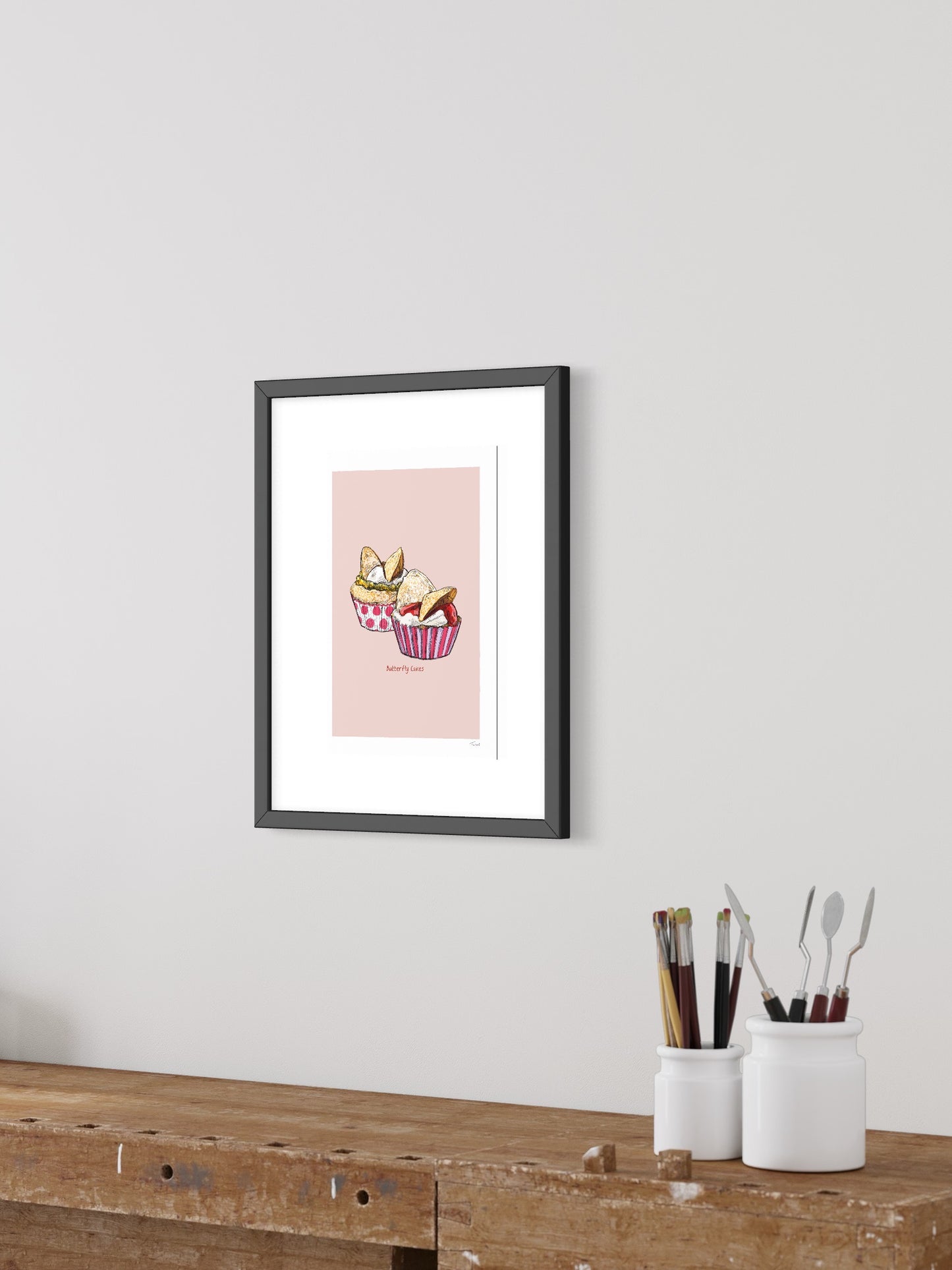 This image shows a giclee wall art print by Tom Laird Illustration of Butterfly Cakes, framed in a beautiful living room with tasteful modern home decor. This art print is available from Tom Laird Illustration in various sizes.