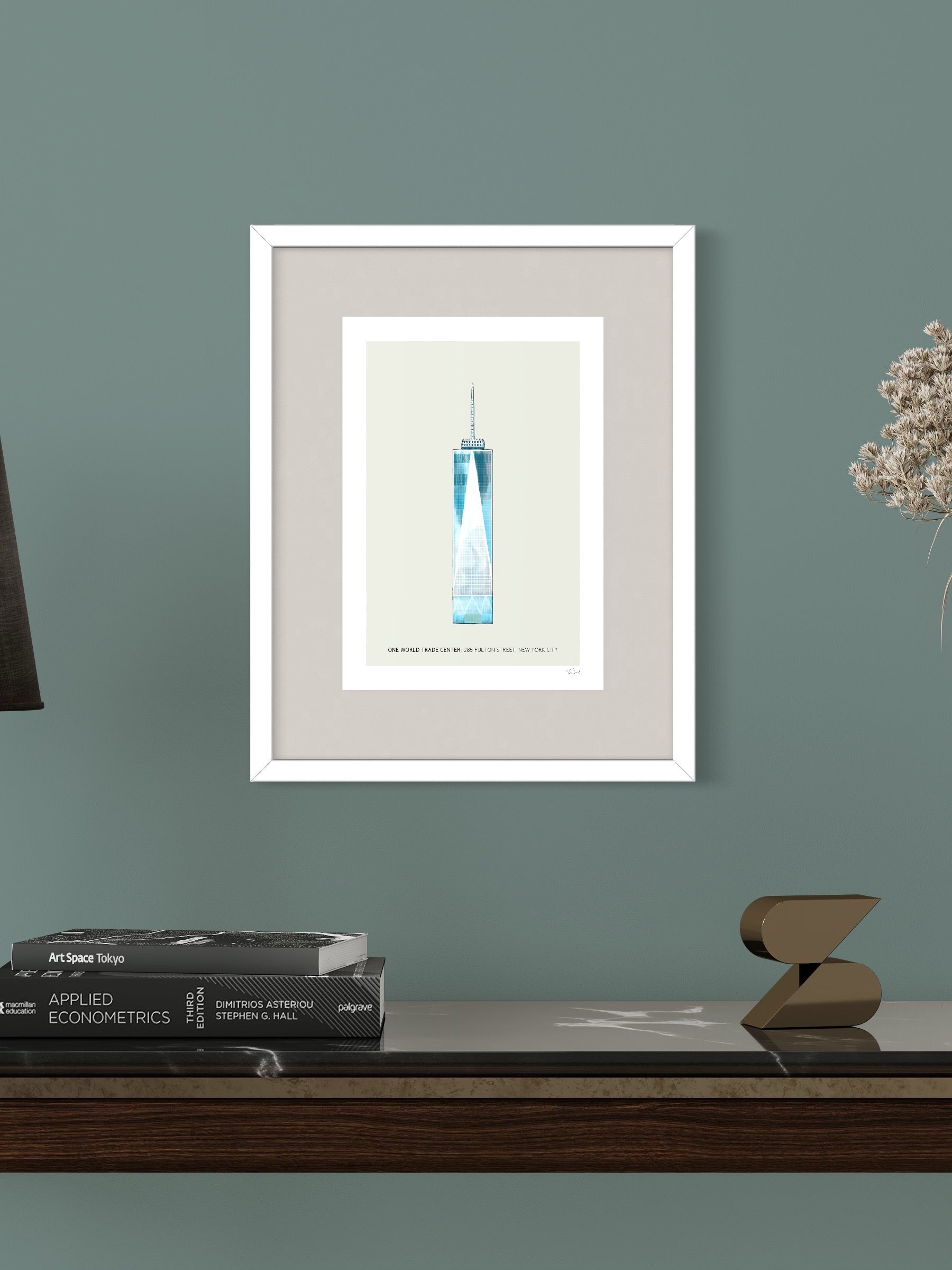This image shows a giclee wall art print by Tom Laird Illustration of the world-famous New York City landmark the One World Trade Center, framed in a beautiful living room with tasteful modern home decor. This art print is available from Tom Laird Illustration in A4 size.