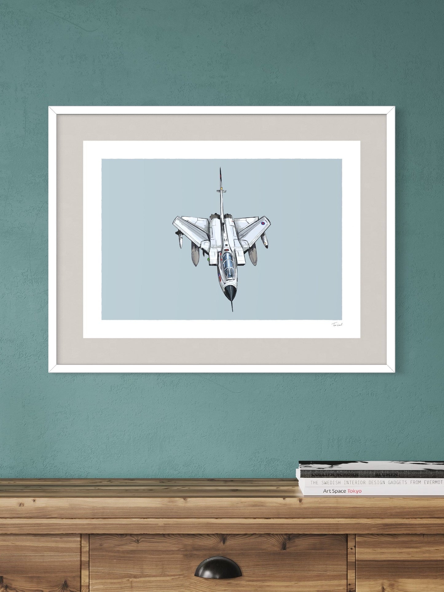 This image shows a giclee wall art print by Tom Laird Illustration of the British classic plane, the Tornado, framed in a beautiful living room with tasteful modern home decor. This art print is available from Tom Laird Illustration in a variety of sizes.