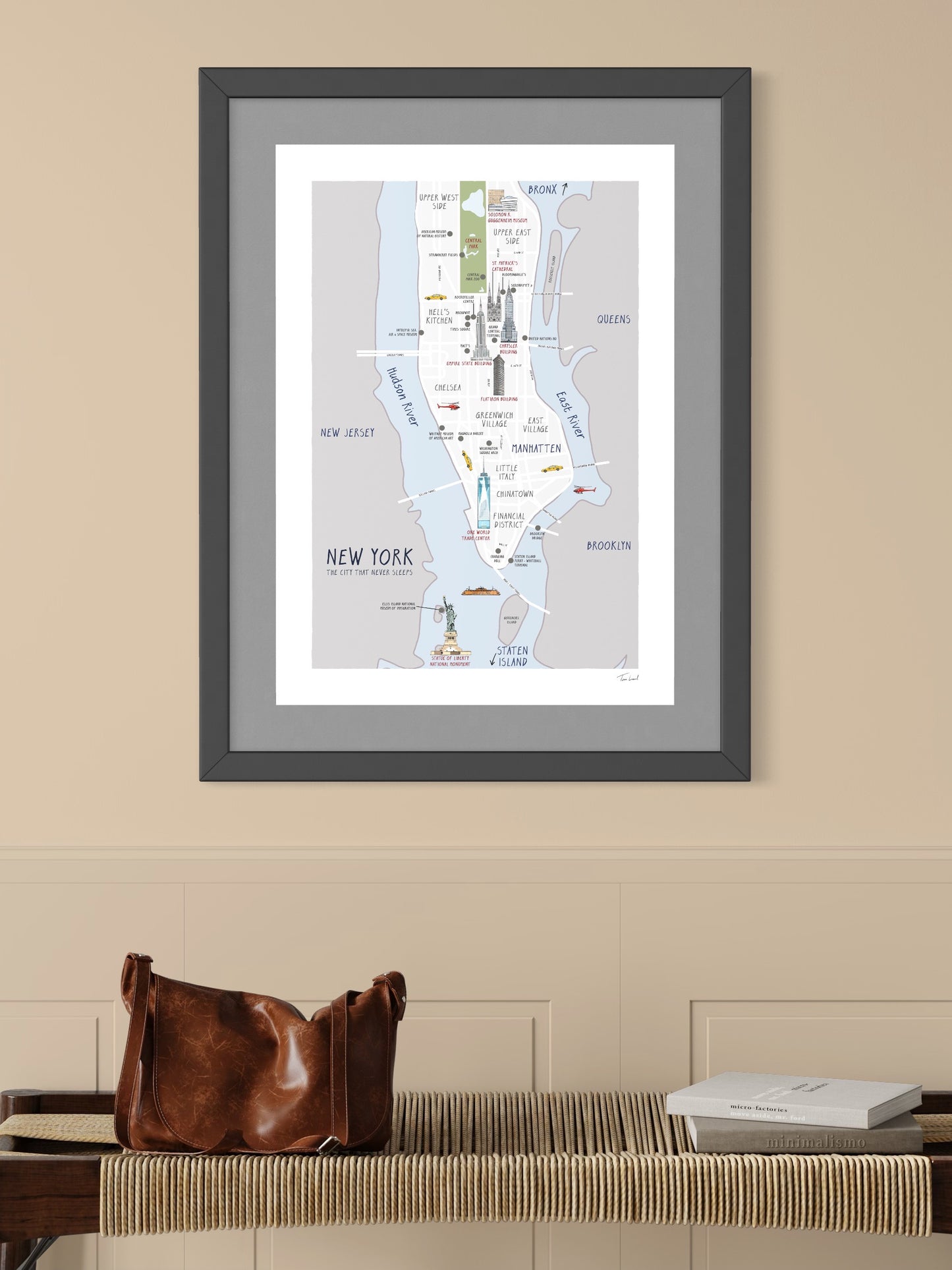 This image shows a giclee wall art print by Tom Laird Illustration of a New York City map features illustrations of seven of the city’s most iconic landmarks, such as the Statue of Liberty, Empire State Building, and Chrysler Building, framed in a beautiful living room with tasteful modern home decor. This art print is available from Tom Laird Illustration in A4 size.