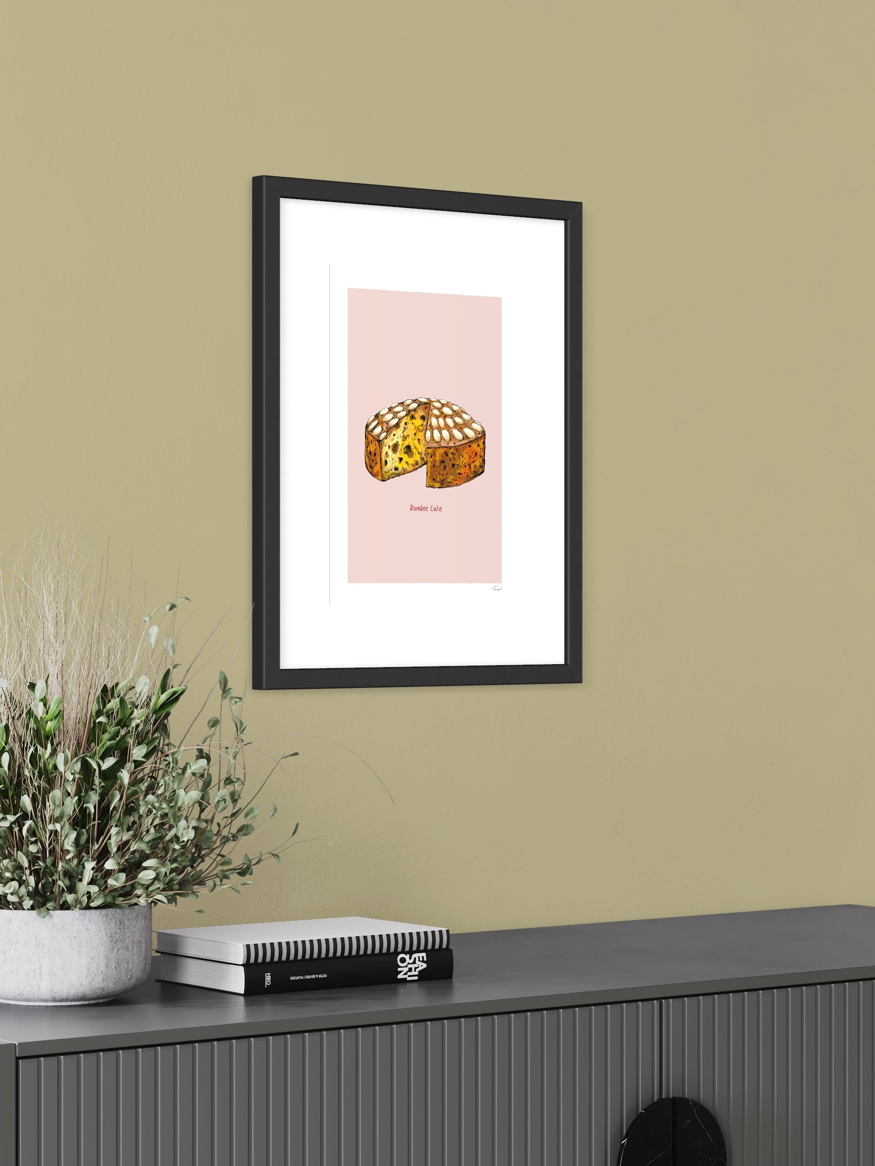 This image shows a giclee wall art print by Tom Laird Illustration of a Dundee Cake, framed in a beautiful living room with tasteful modern home decor. This art print is available from Tom Laird Illustration in various sizes.