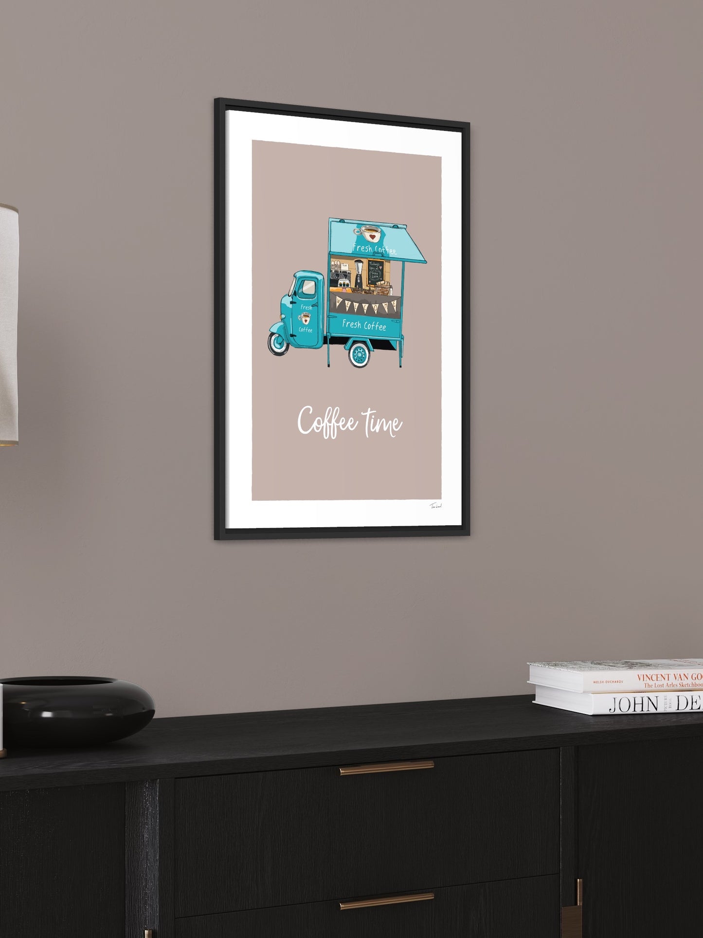 This image shows a giclee wall art print by Tom Laird Illustration of a little barista coffee tuk tuk, framed in a beautiful living room with tasteful modern home decor. This art print is available from Tom Laird Illustration in various sizes.