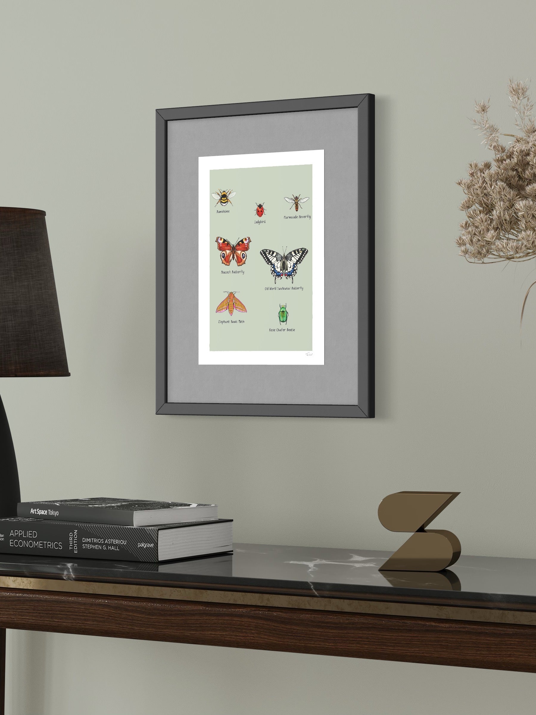 This image shows a giclee wall art print by Tom Laird Illustration of a Pollinating Insects of Great Britain, framed in a beautiful living room with tasteful modern home decor. This art print is available from Tom Laird Illustration in various sizes.