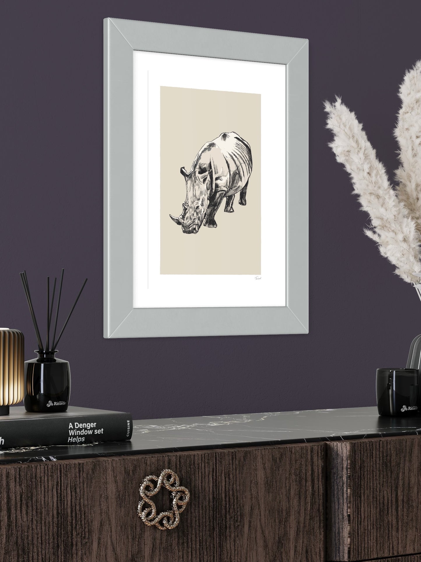 This image shows a giclee wall art print by Tom Laird Illustration of a Rhino, framed in a beautiful living room with tasteful modern home decor. This art print is available from Tom Laird Illustration in various sizes.